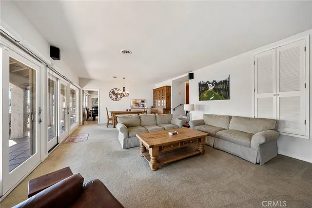 a dining room with furniture a chandelier and fireplace