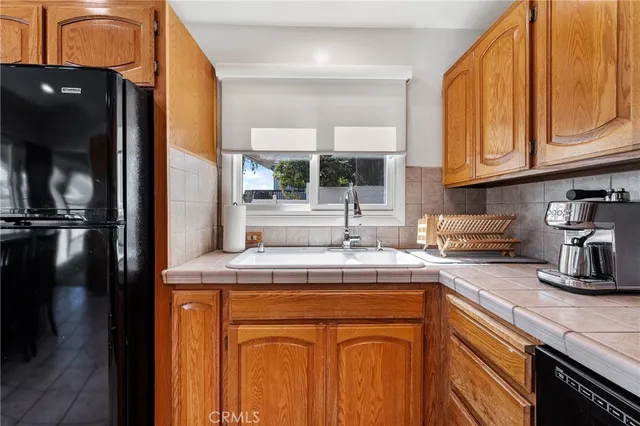 a spacious bedroom with a bed and a lamp