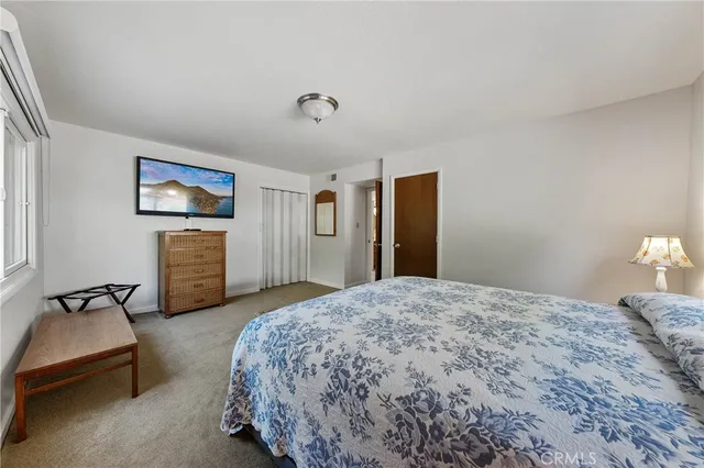 a bedroom with a bed and a lamp