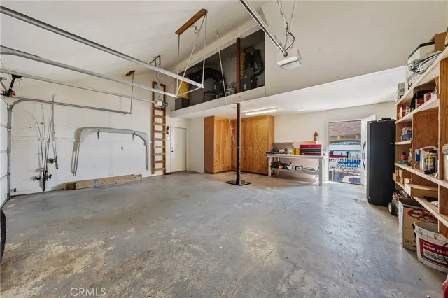 an aerial view of a house with pool table and chairs under an umbrella