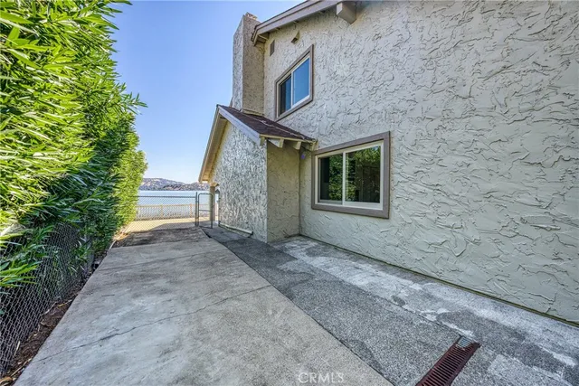 an aerial view of a house with swimming pool patio and lake view
