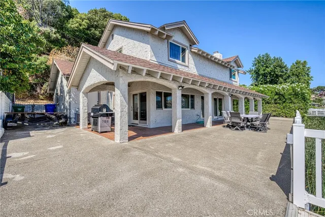 an aerial view of a house with swimming pool and a yard