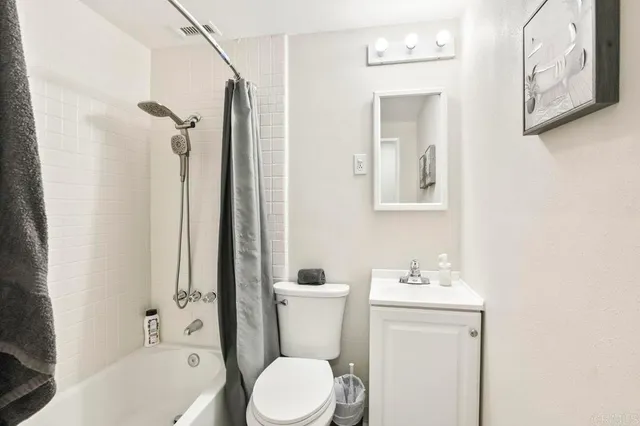 a large bed sitting in a bedroom next to a window