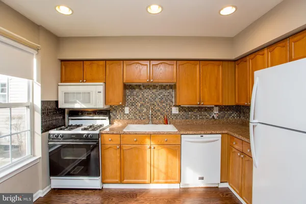 a kitchen with a stove a refrigerator and a sink