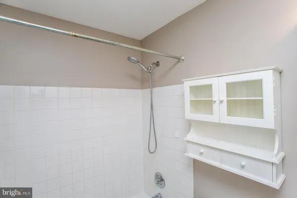 a bathroom with a window and a shower