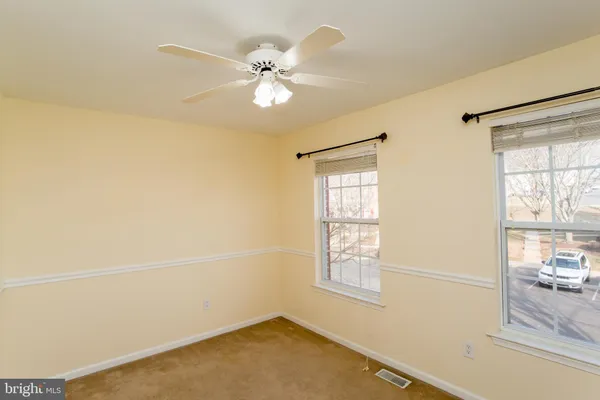 a view of a room with a window and ceiling fan