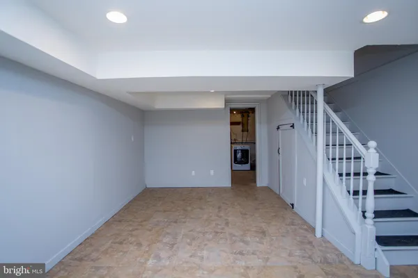 a view of an empty room with stairs