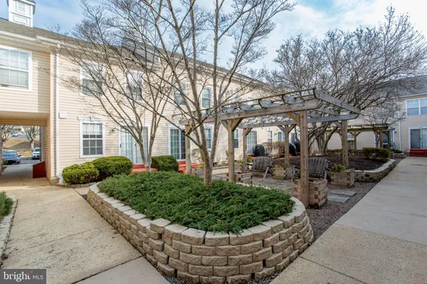 a view of a house with a yard and pathway