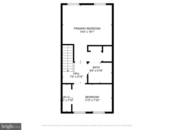 a picture of a bench in front of a wall