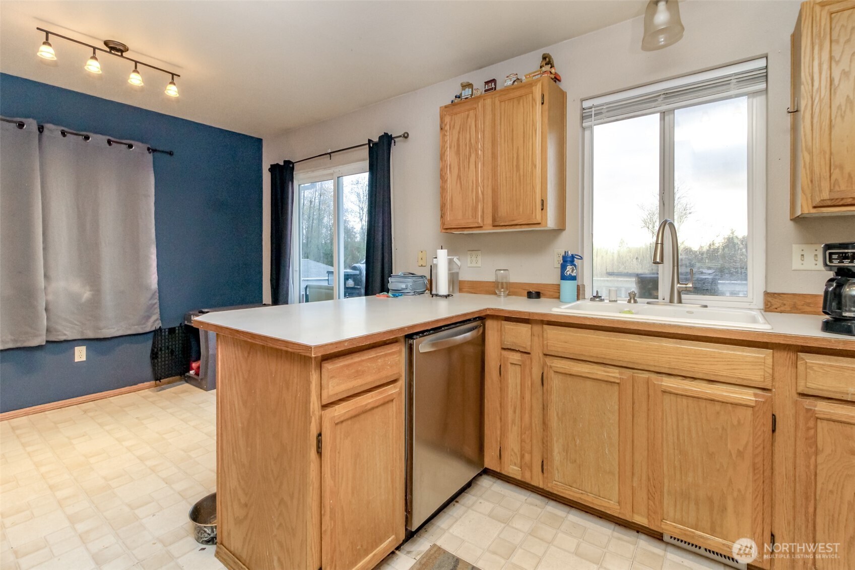 249 South Elsa Street Buckley, WA 98321 - Photo 12 of 37 a kitchen with stainless steel appliances granite countertop a sink a stove and a refrigerator