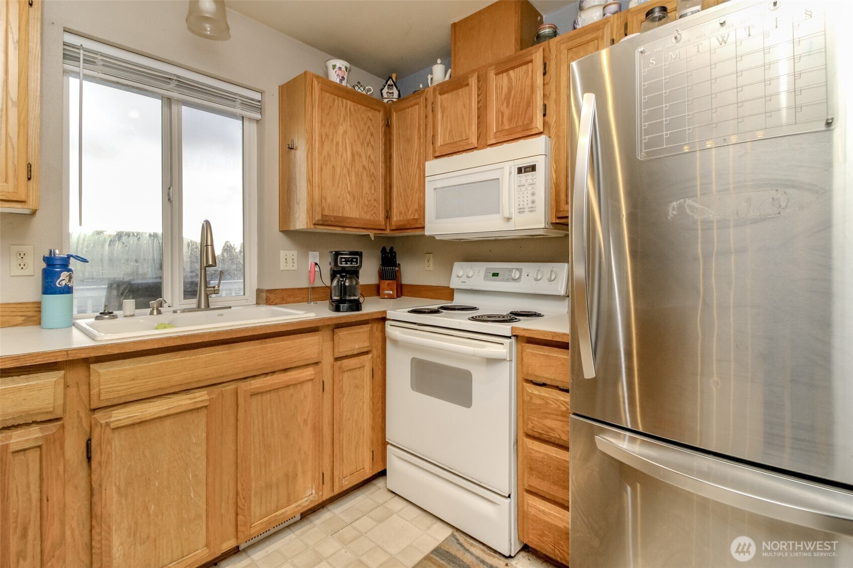 249 South Elsa Street Buckley, WA 98321 - Photo 13 of 37 a kitchen with white cabinets and white appliances