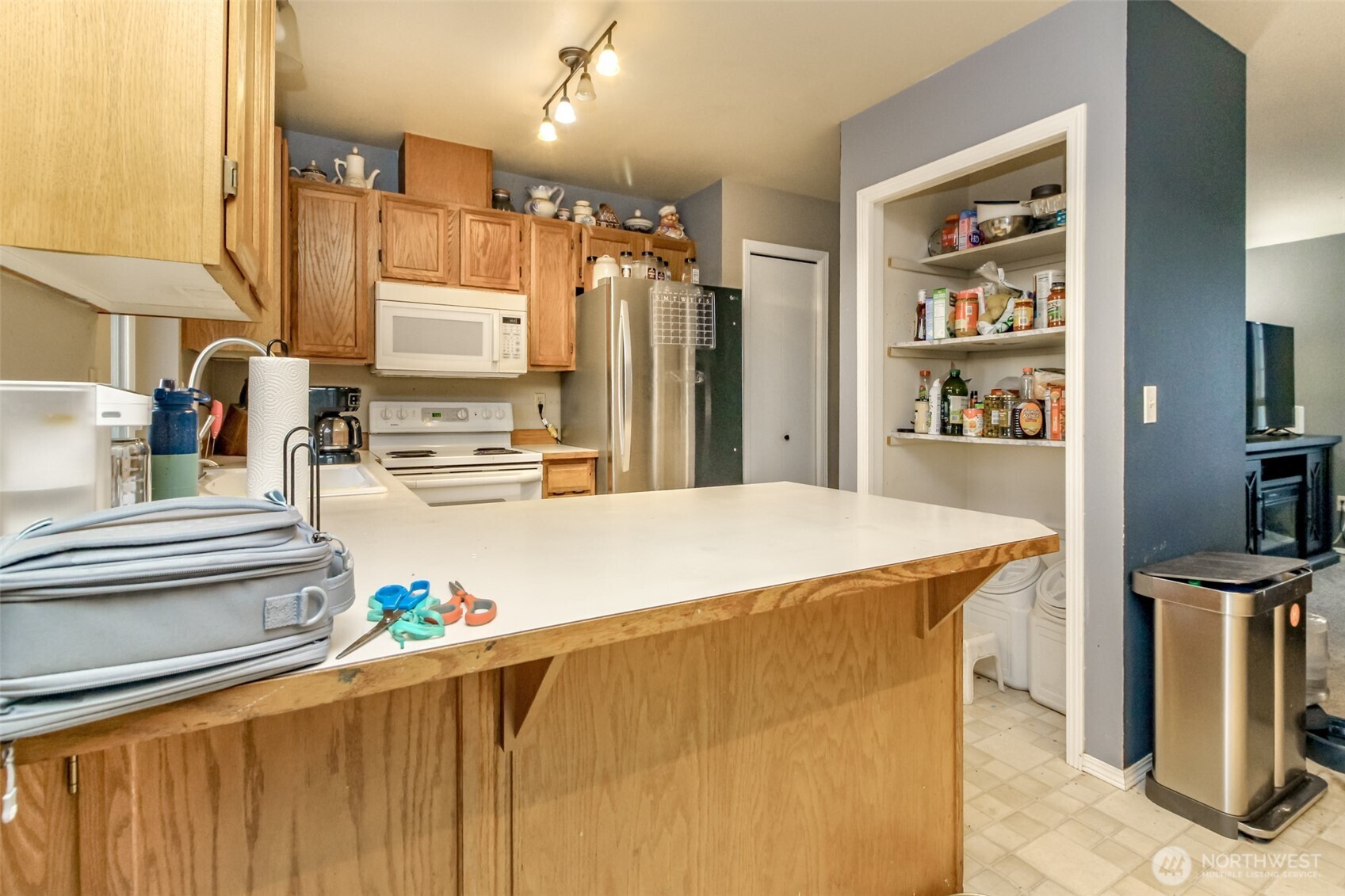 249 South Elsa Street Buckley, WA 98321 - Photo 15 of 37 a large kitchen with kitchen island a stove a sink and a refrigerator