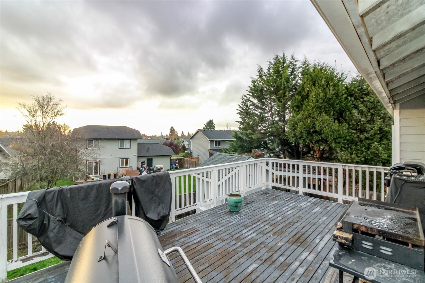 249 South Elsa Street Buckley, WA 98321 - Photo 29 of 37 a view of a roof deck with table and chairs with wooden floor and fence