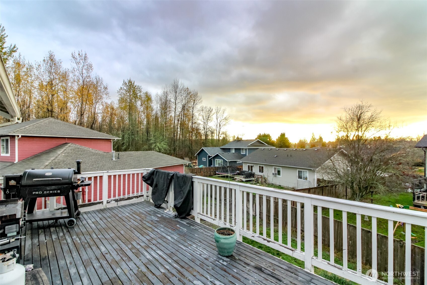 249 South Elsa Street Buckley, WA 98321 - Photo 30 of 37 a view of a roof deck with table and chairs a barbeque with wooden floor and fence