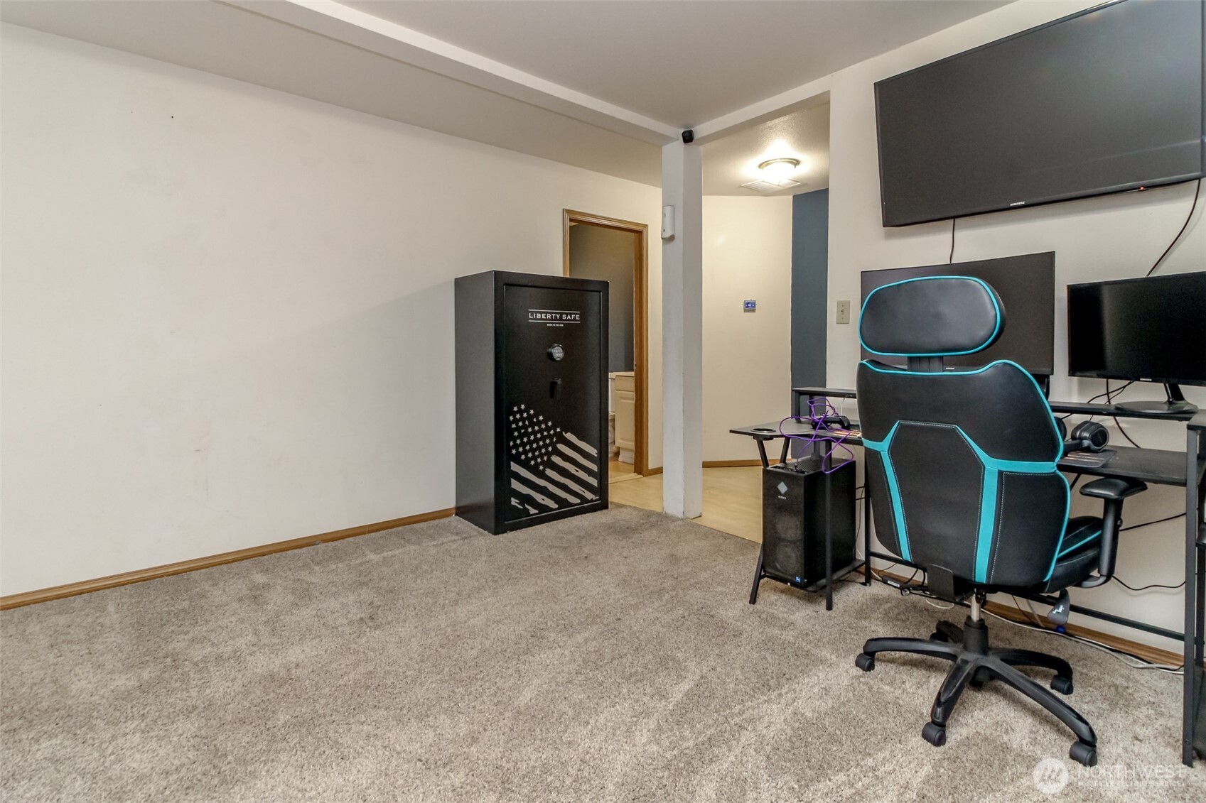 249 South Elsa Street Buckley, WA 98321 - Photo 7 of 37 a view of a workspace with furniture and a flat screen tv