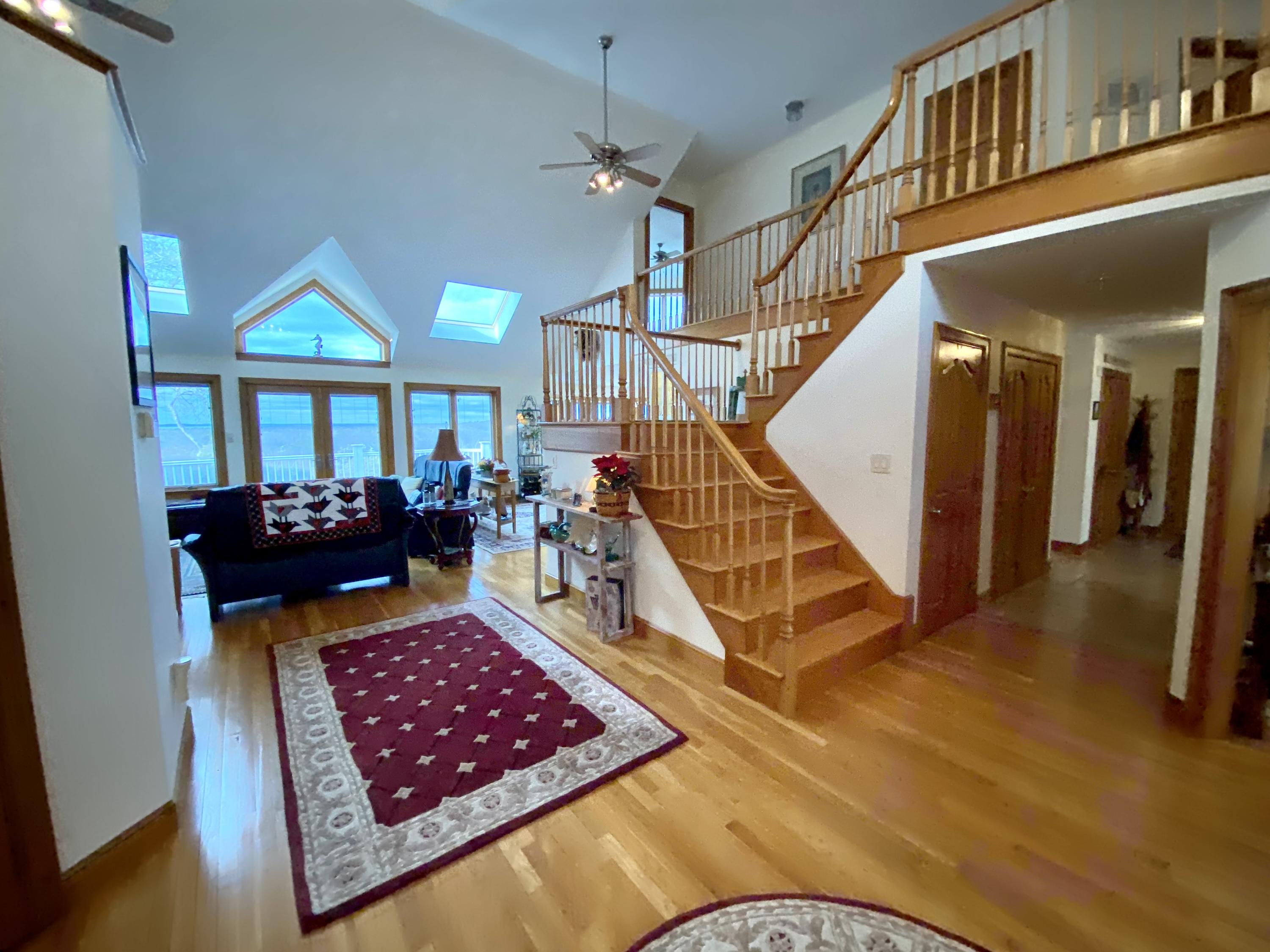 294 Cairn Ridge Road East Falmouth, MA 02536 - Photo 13 of 29 a living room with a rug stairs and a rug