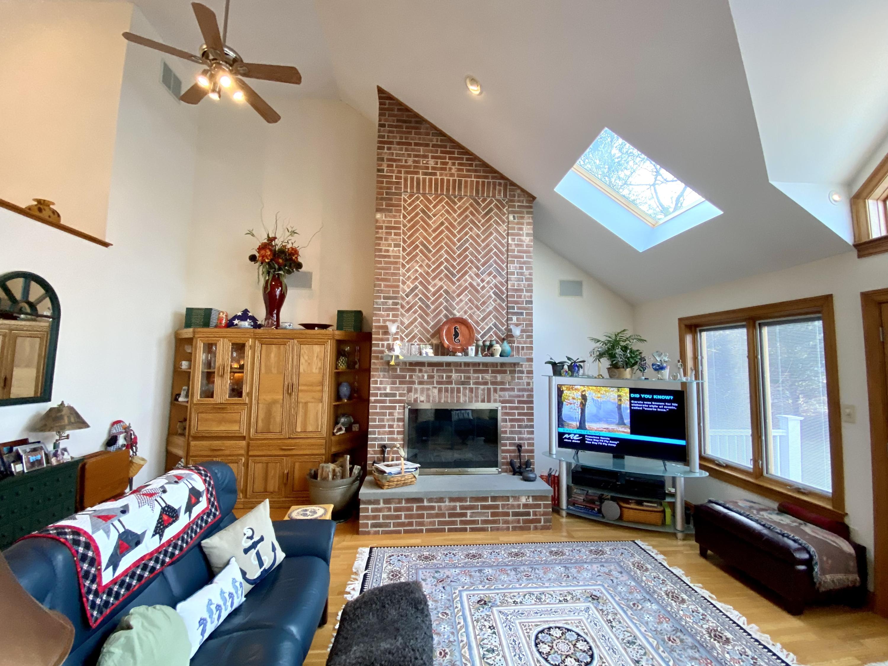 294 Cairn Ridge Road East Falmouth, MA 02536 - Photo 14 of 29 a living room with furniture a flat screen tv and a fireplace
