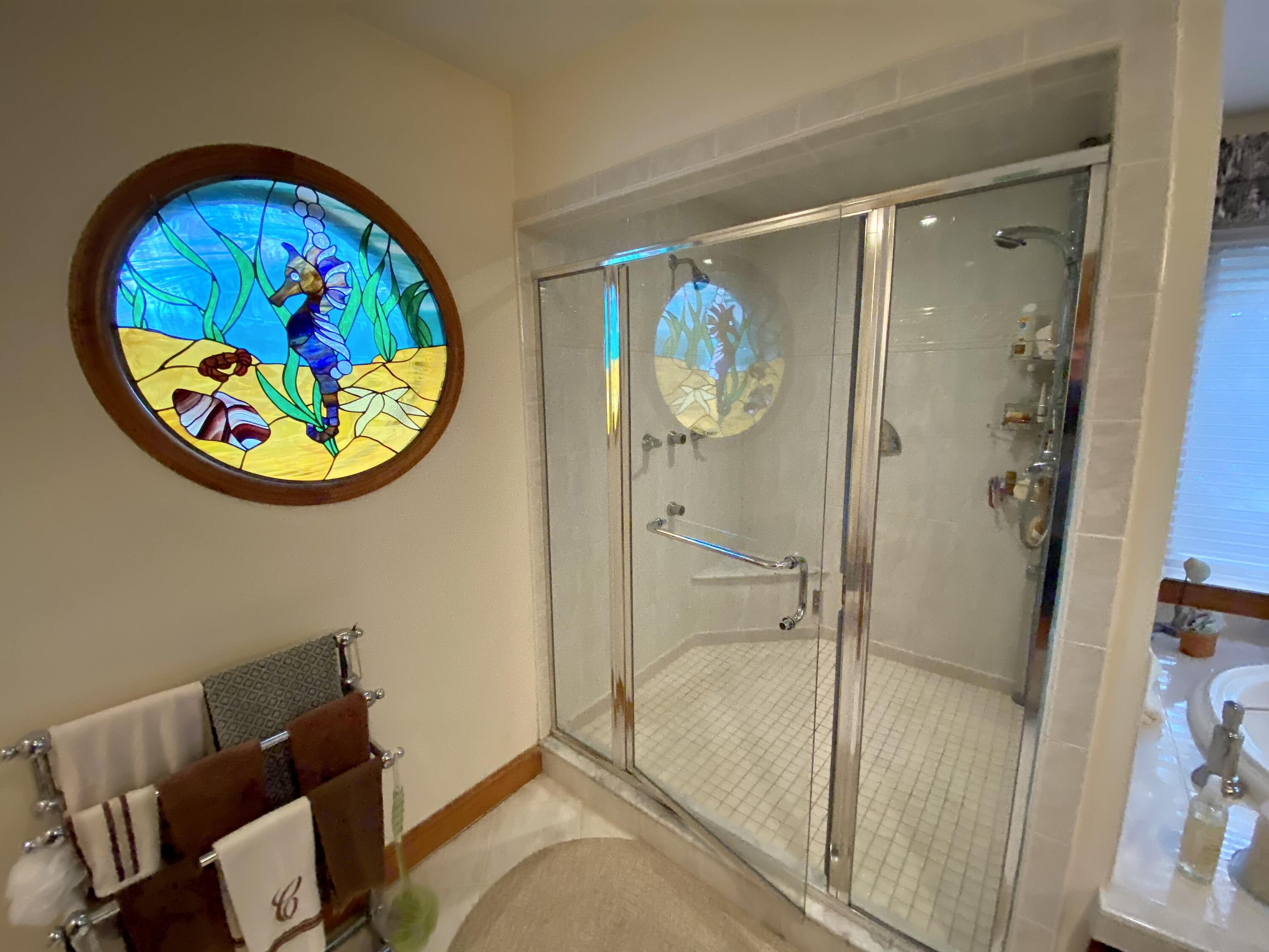 294 Cairn Ridge Road East Falmouth, MA 02536 - Photo 17 of 29 a bathroom with a tub and a painting on the wall