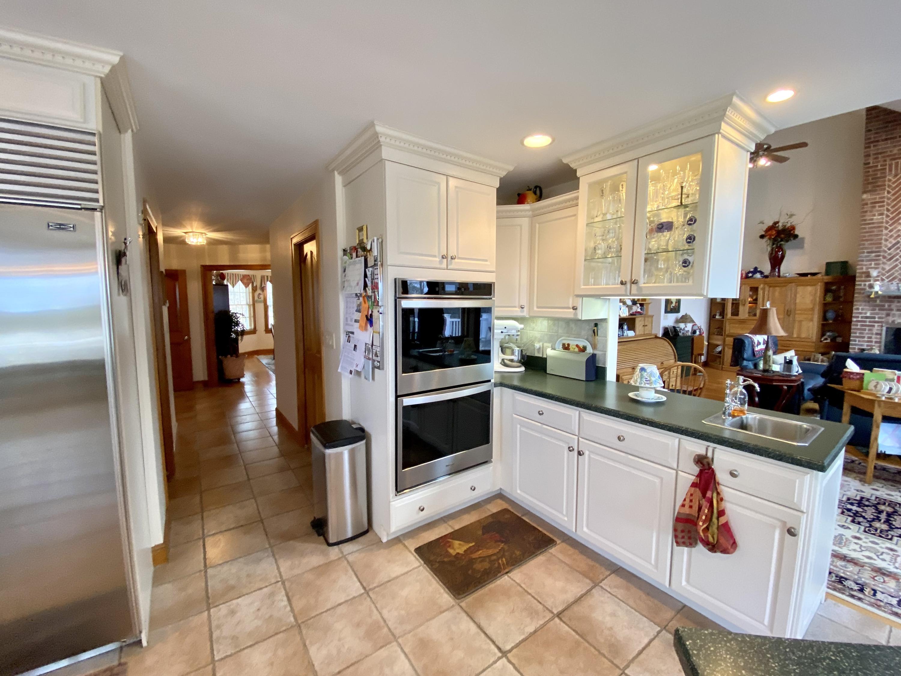 294 Cairn Ridge Road East Falmouth, MA 02536 - Photo 19 of 29 a kitchen with stainless steel appliances kitchen island granite countertop a refrigerator and a sink