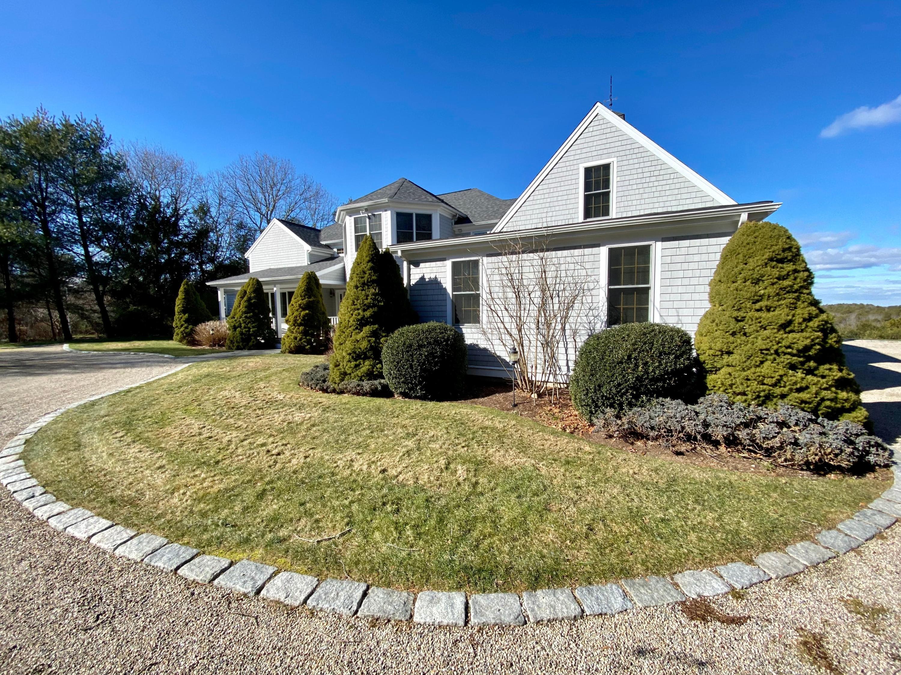 294 Cairn Ridge Road East Falmouth, MA 02536 - Photo 4 of 29 a front view of a house with a yard