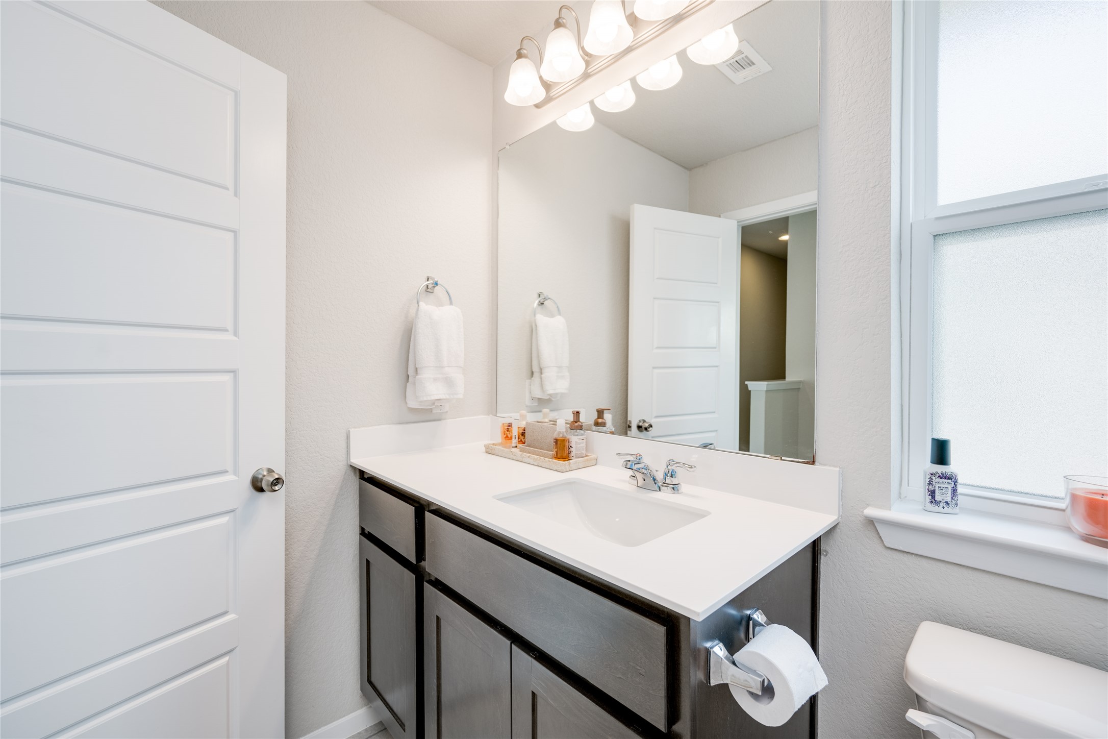 7948 Castelardo Place Round Rock, TX 78665 - Photo 24 of 32 a bathroom with a sink a toilet and a mirror
