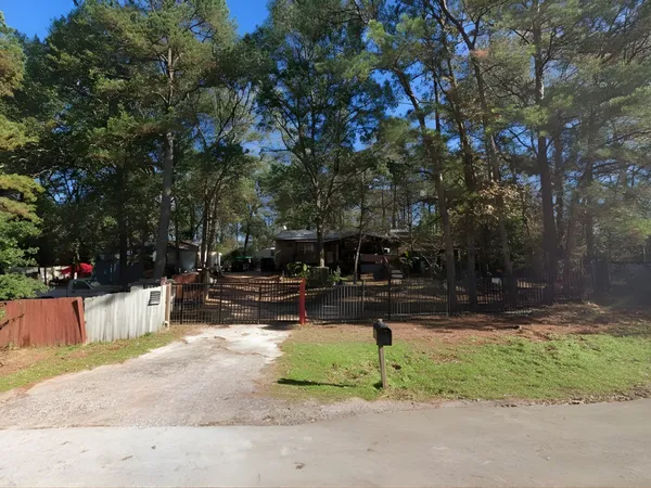 a view of backyard with a small play house and a bench