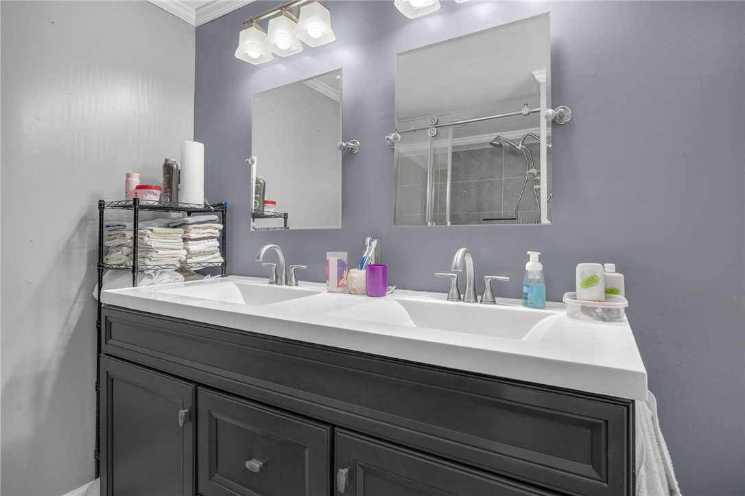 1549 Bethany Church Road Belton, SC 29627 - Photo 22 of 36 Double vanity with sleek dark cabinetry and polished chrome fixtures offers practical elegance.