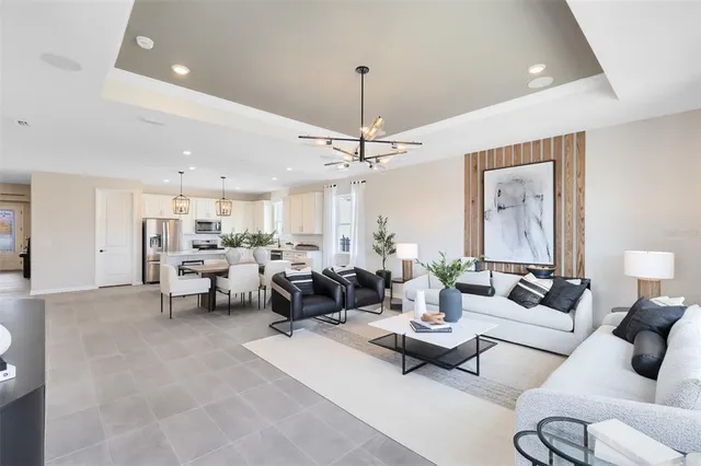 a living room with furniture potted plant and a chandelier
