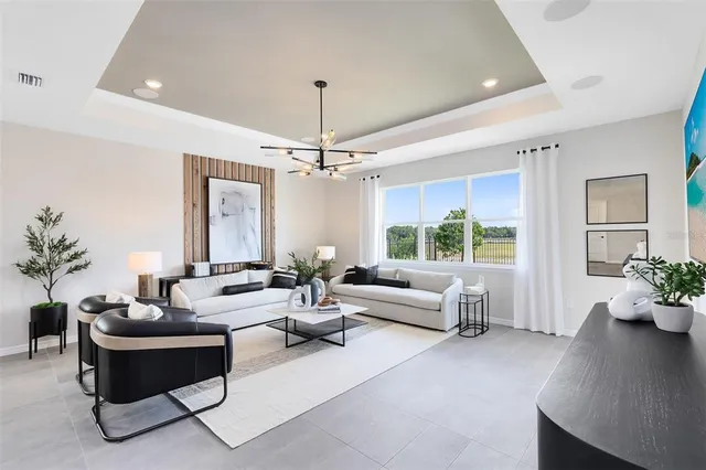 a living room with furniture and a chandelier