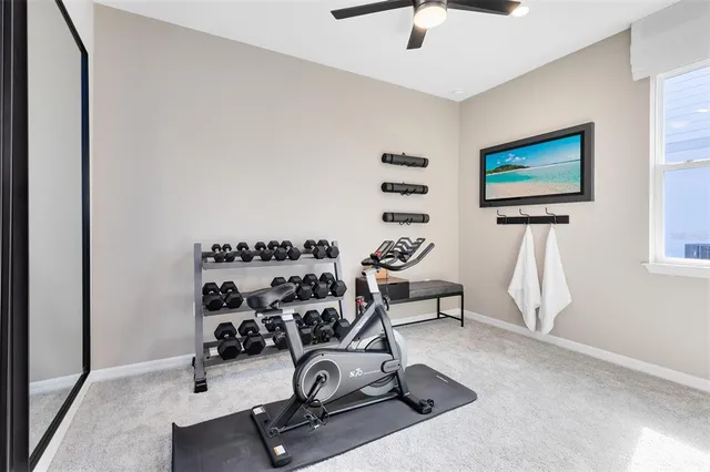 a view of a hallway to a livingroom with furniture