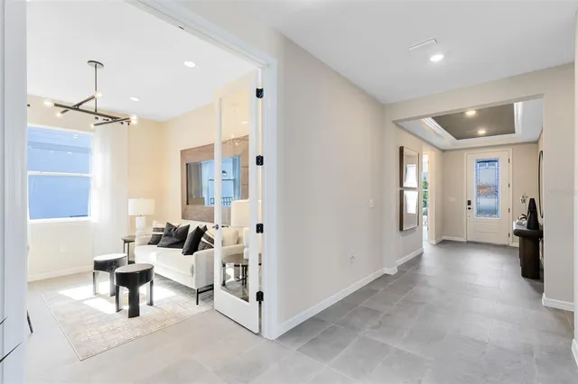 a living room with furniture a rug and a chandelier