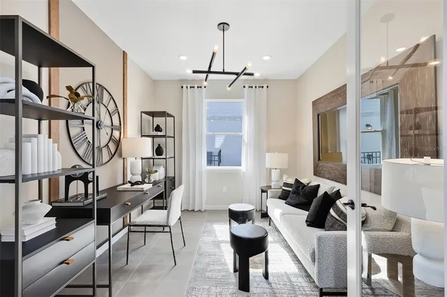 a large white kitchen with lots of counter top space a sink dining table and chairs
