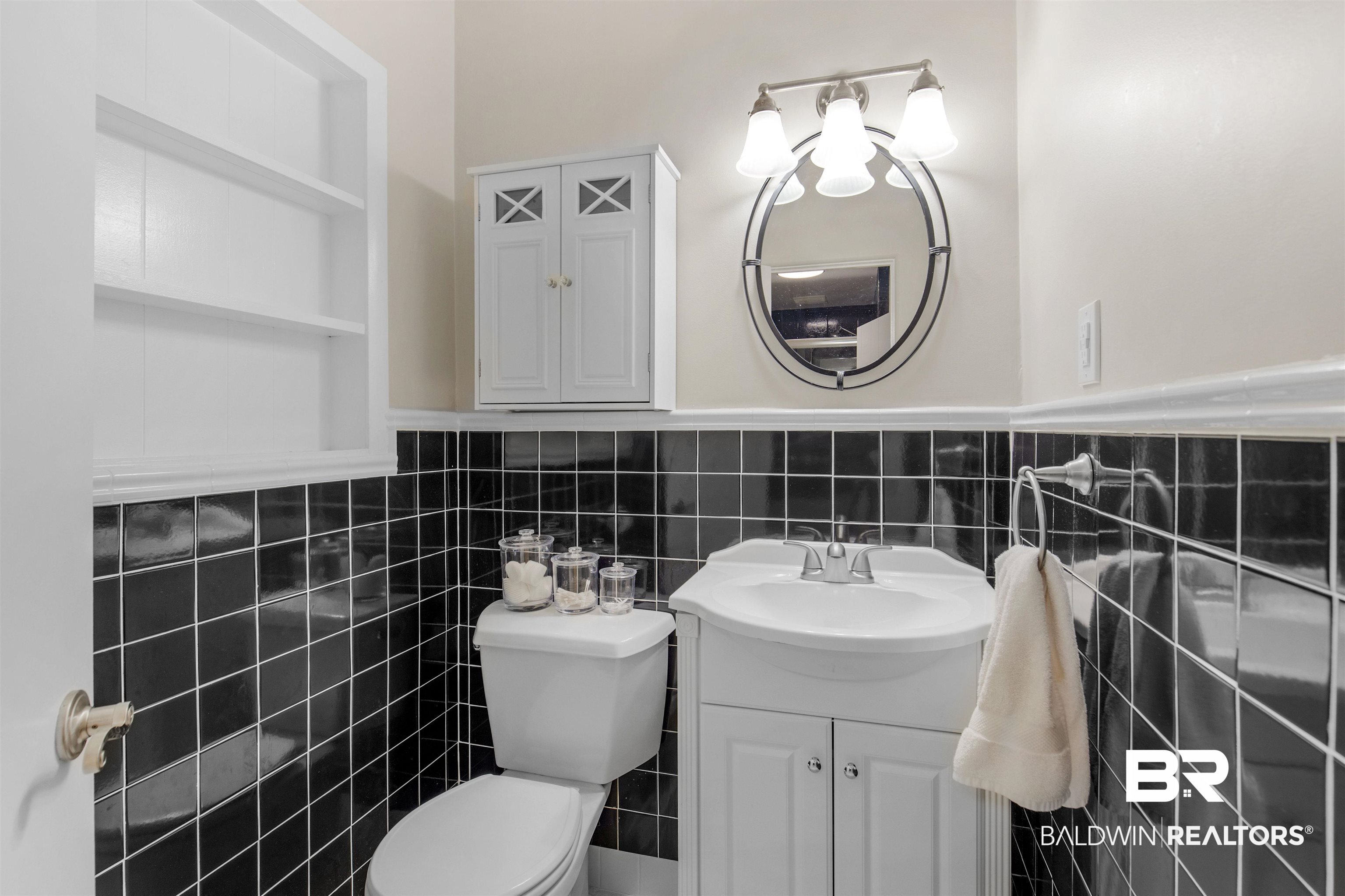4306 Michael Boulevard Mobile, AL 36609 - Photo 18 of 35 Bathroom featuring vanity, tile walls, and toilet