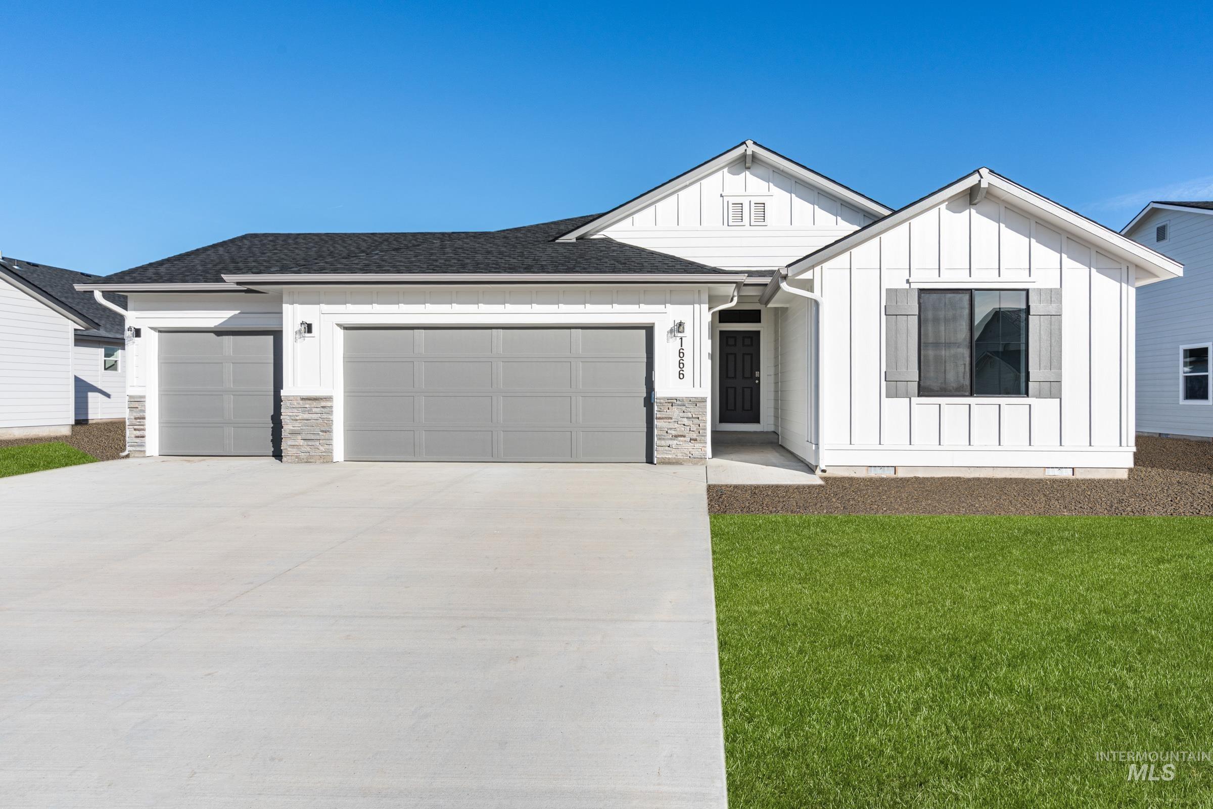 1666 Dyer Street Middleton, ID 83644 - Photo 1 of 1 Modern farmhouse style home with board and batten siding, driveway, an attached garage, and stone siding