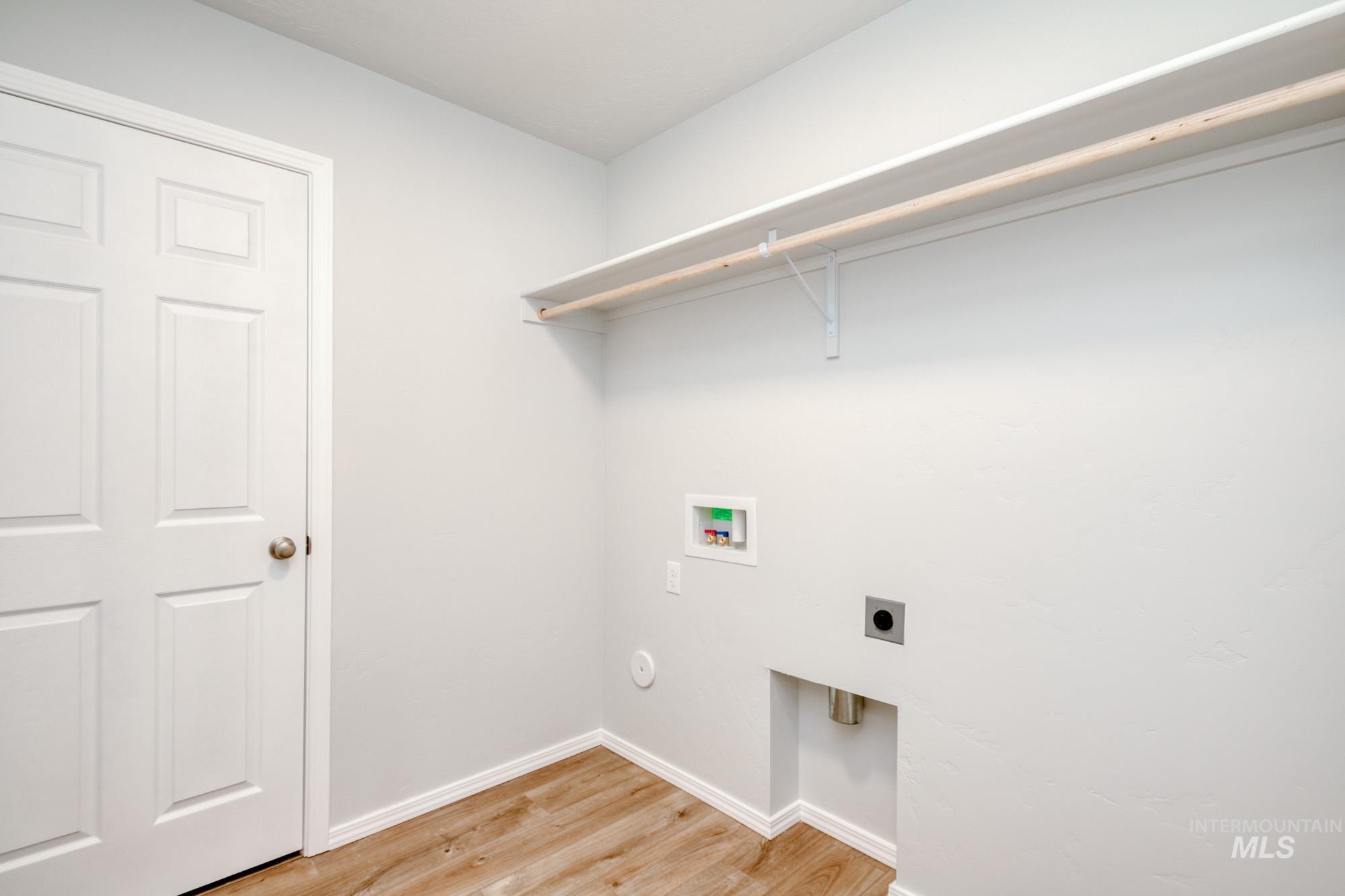 1666 Dyer Street Middleton, ID 83644 - Photo 17 of 22 Laundry room with light wood-type flooring, hookup for an electric dryer, and washer hookup