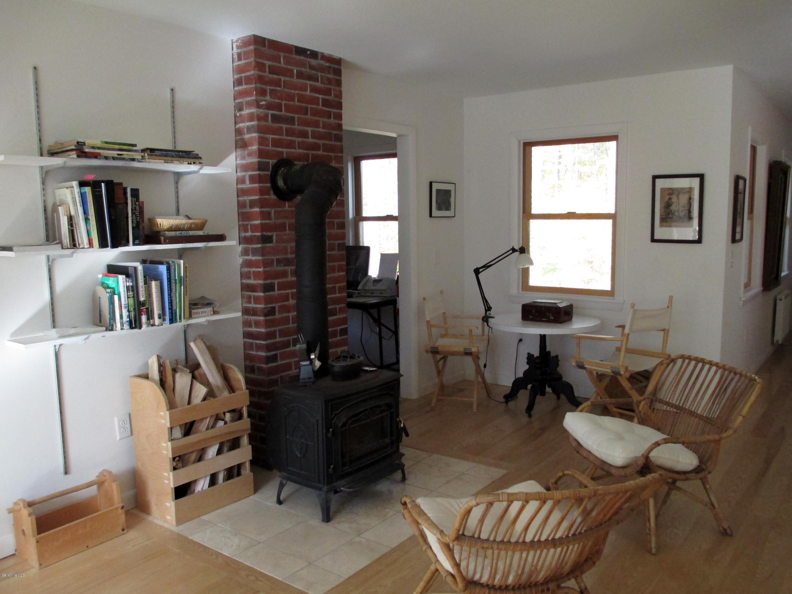 170 Leland Road Becket, MA 01223 - Photo 15 of 59 a living room with furniture a piano and a bookshelf