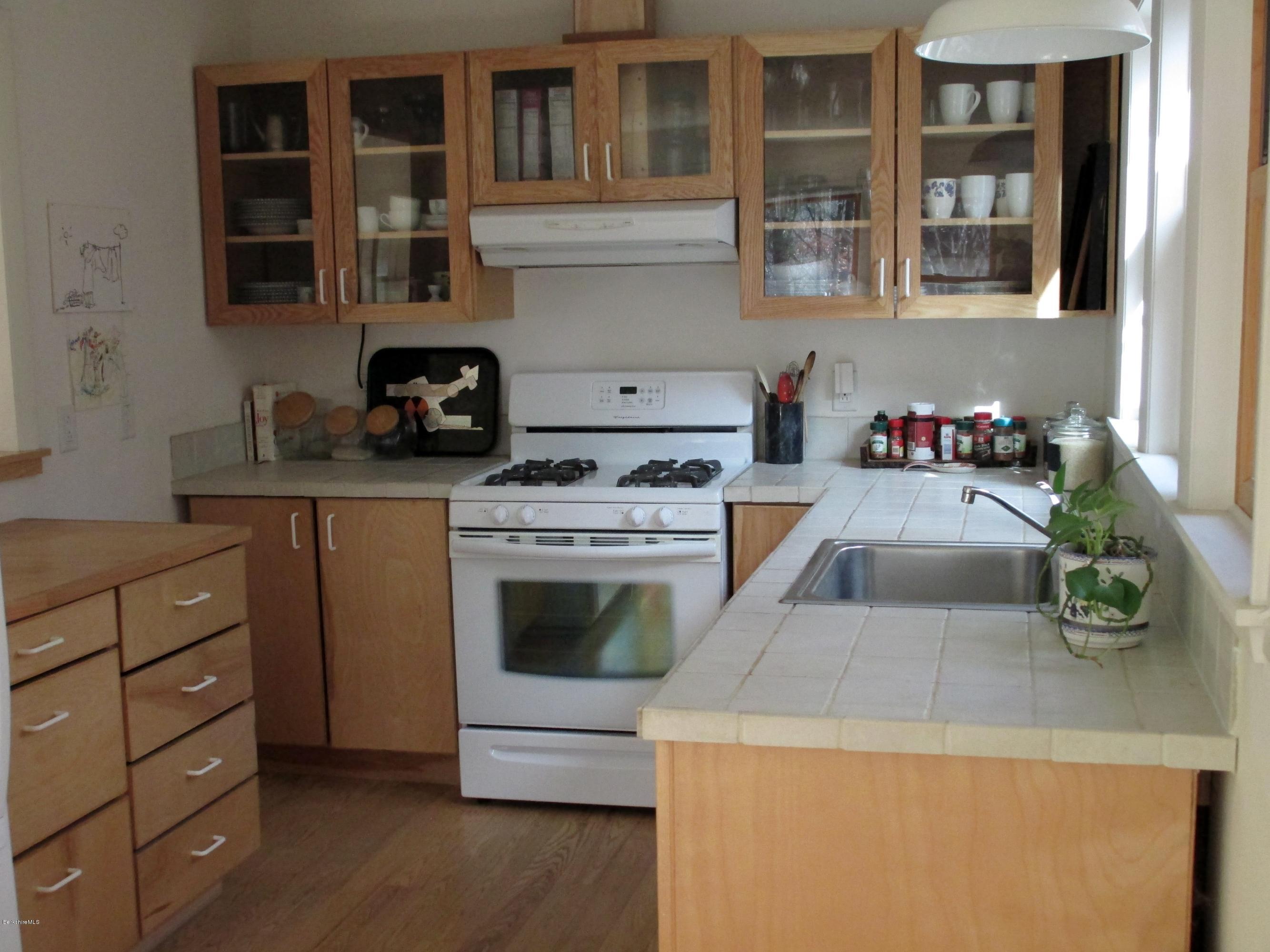 170 Leland Road Becket, MA 01223 - Photo 22 of 59 a kitchen with a stove and a white cabinets