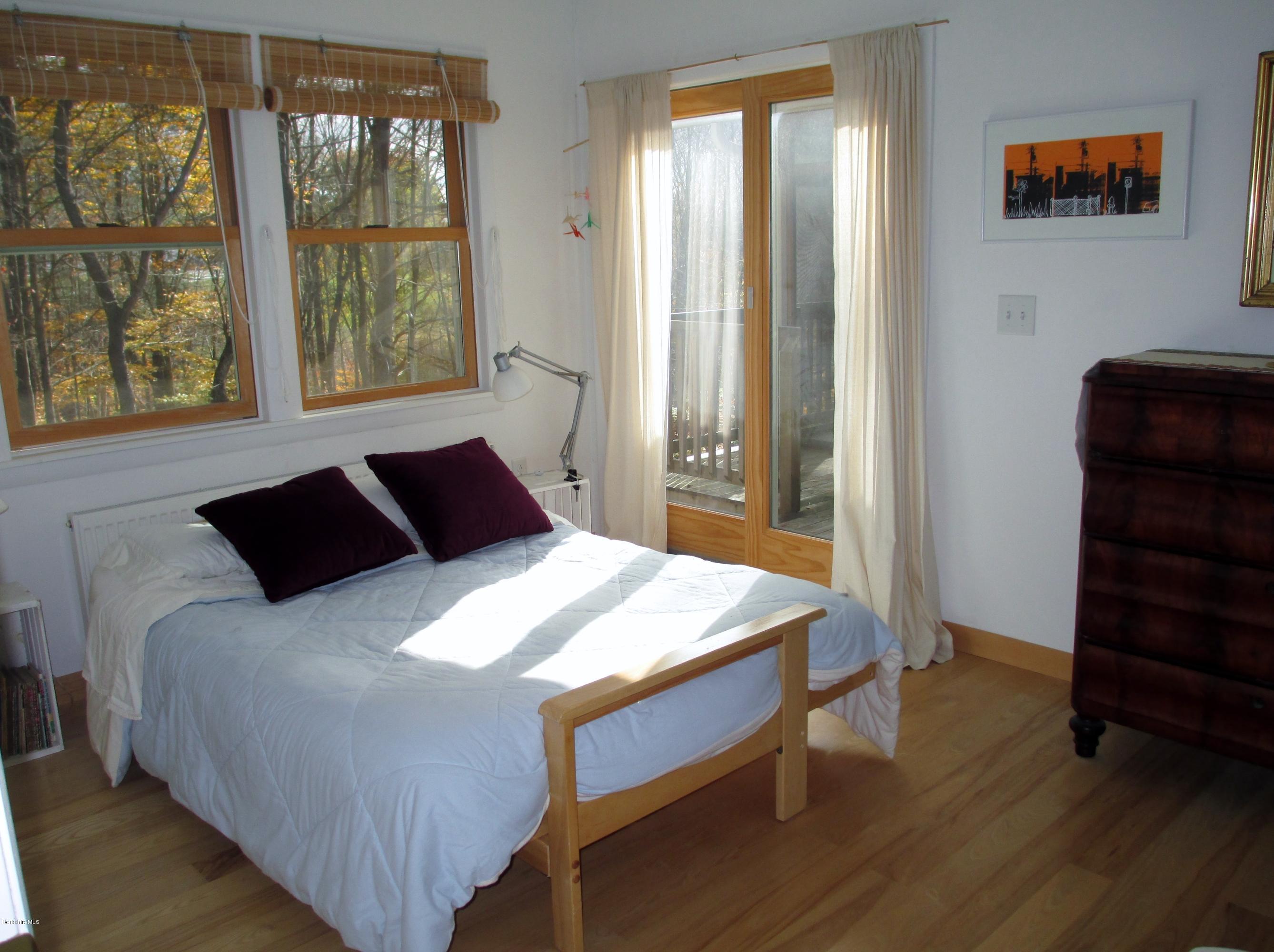 170 Leland Road Becket, MA 01223 - Photo 30 of 59 a bedroom with a bed and wooden floor