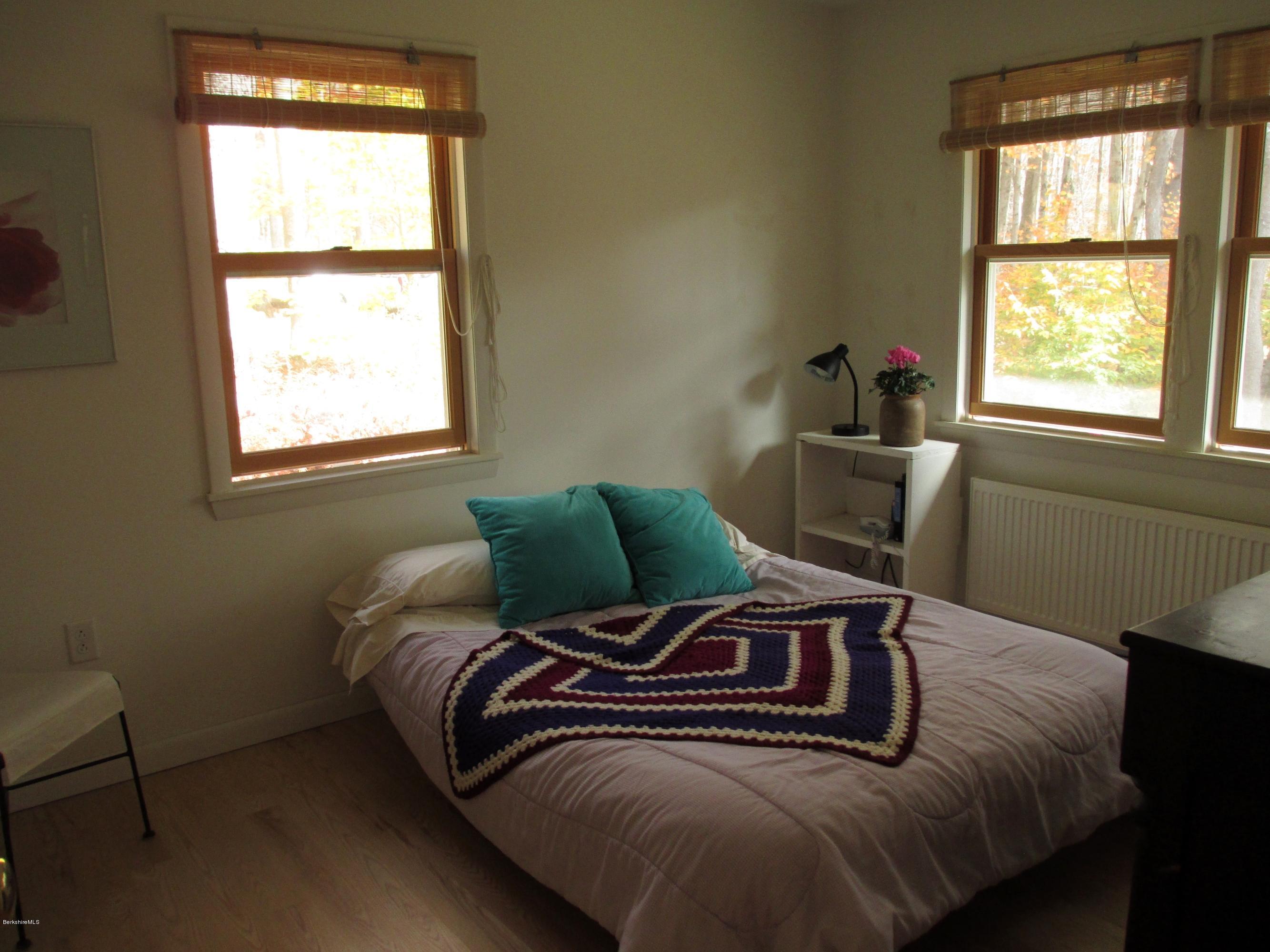 170 Leland Road Becket, MA 01223 - Photo 31 of 59 a bed sitting in a bedroom next to a window
