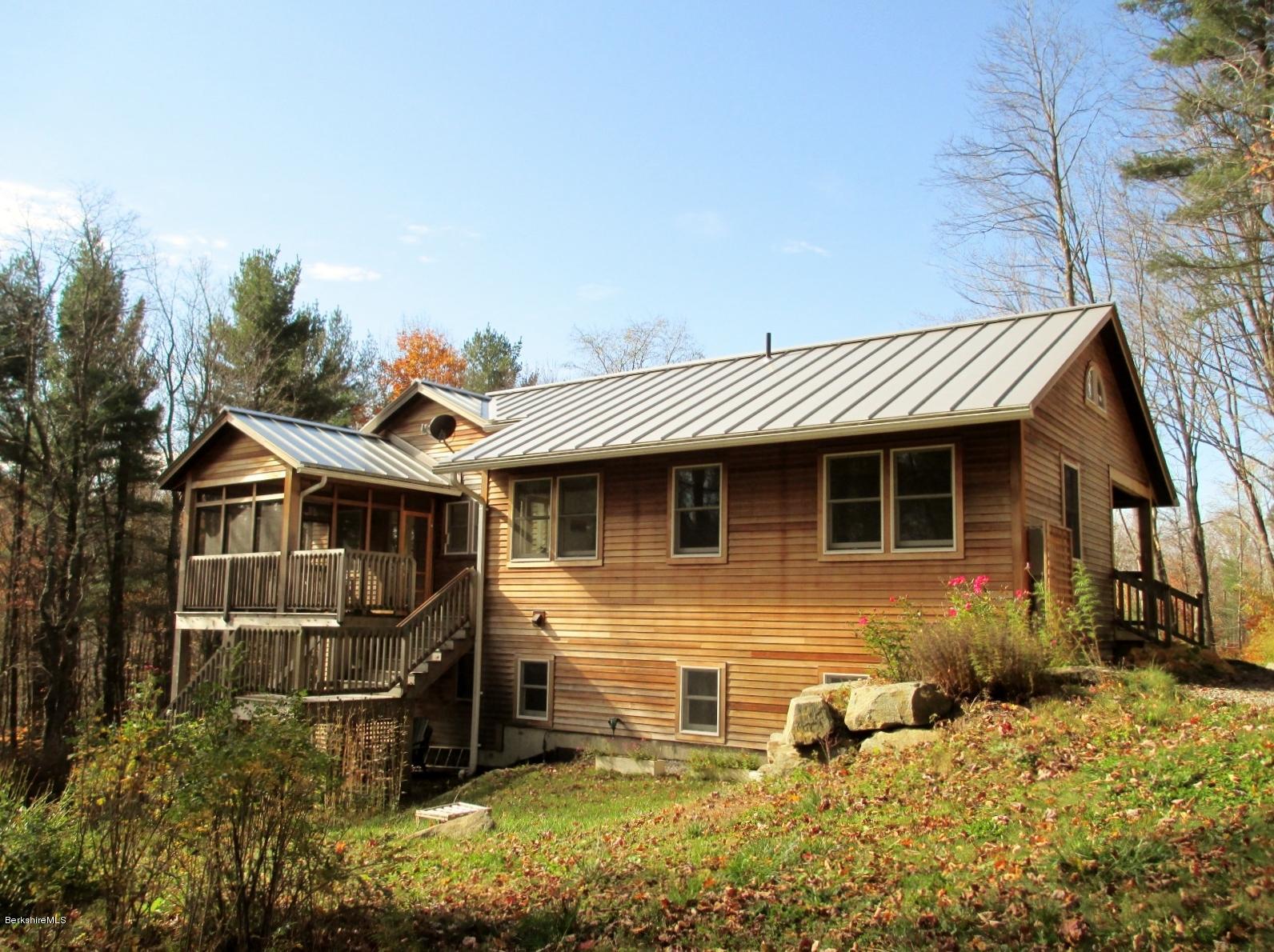 170 Leland Road Becket, MA 01223 - Photo 54 of 59 a view of a house with yard and wooden fence