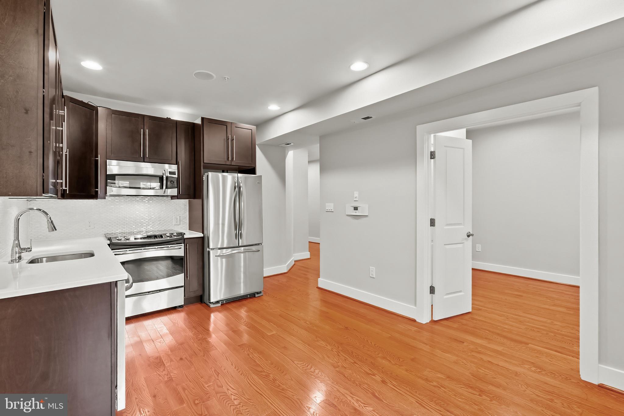 a kitchen with stainless steel appliances granite countertop a refrigerator and a sink