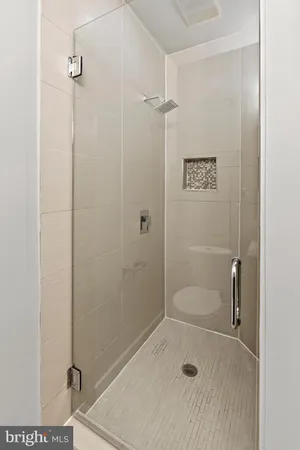 an empty room with wooden floor cabinet and windows