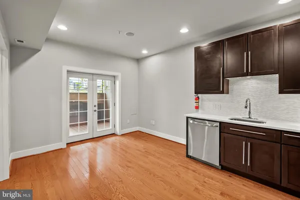a view of a kitchen with a sink and a large mirror