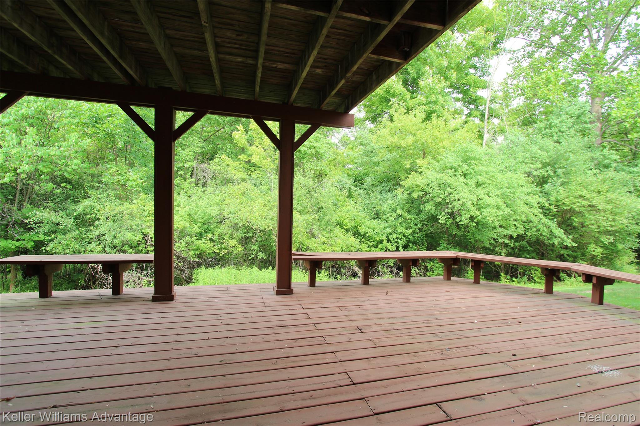 21850 River Ridge Trail Farmington, MI 48335 - Photo 27 of 33 Spacious covered deck featuring wood-finish flooring, sturdy support posts, and built-in perimeter seating