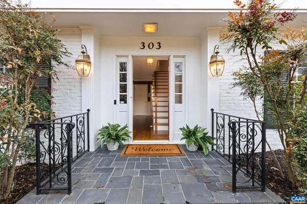 a dining room with furniture a chandelier and wooden floor