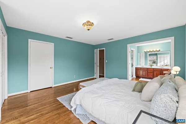 a spacious bedroom with a large bed and a window
