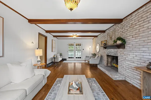 a bedroom with a large bed a table and painting on the wall
