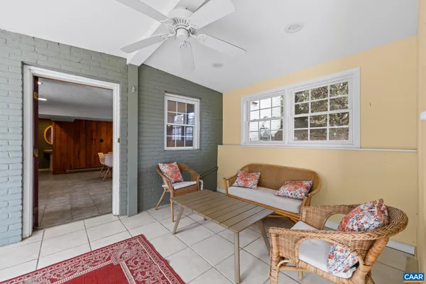 a front view of a house with a yard covered with snow
