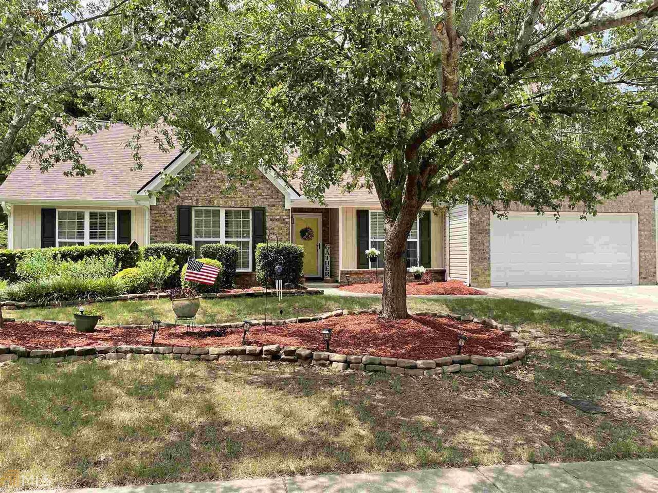 a front view of a house with garden