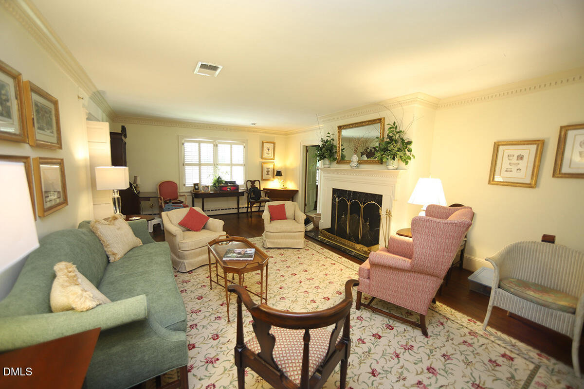 2601 York Road Raleigh, NC 27608 - Photo 2 of 24 a living room with furniture a fireplace and a window